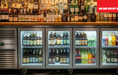 SKOPE ReFlex four-glass-door undercounter fridge in a bar stocked with bottles